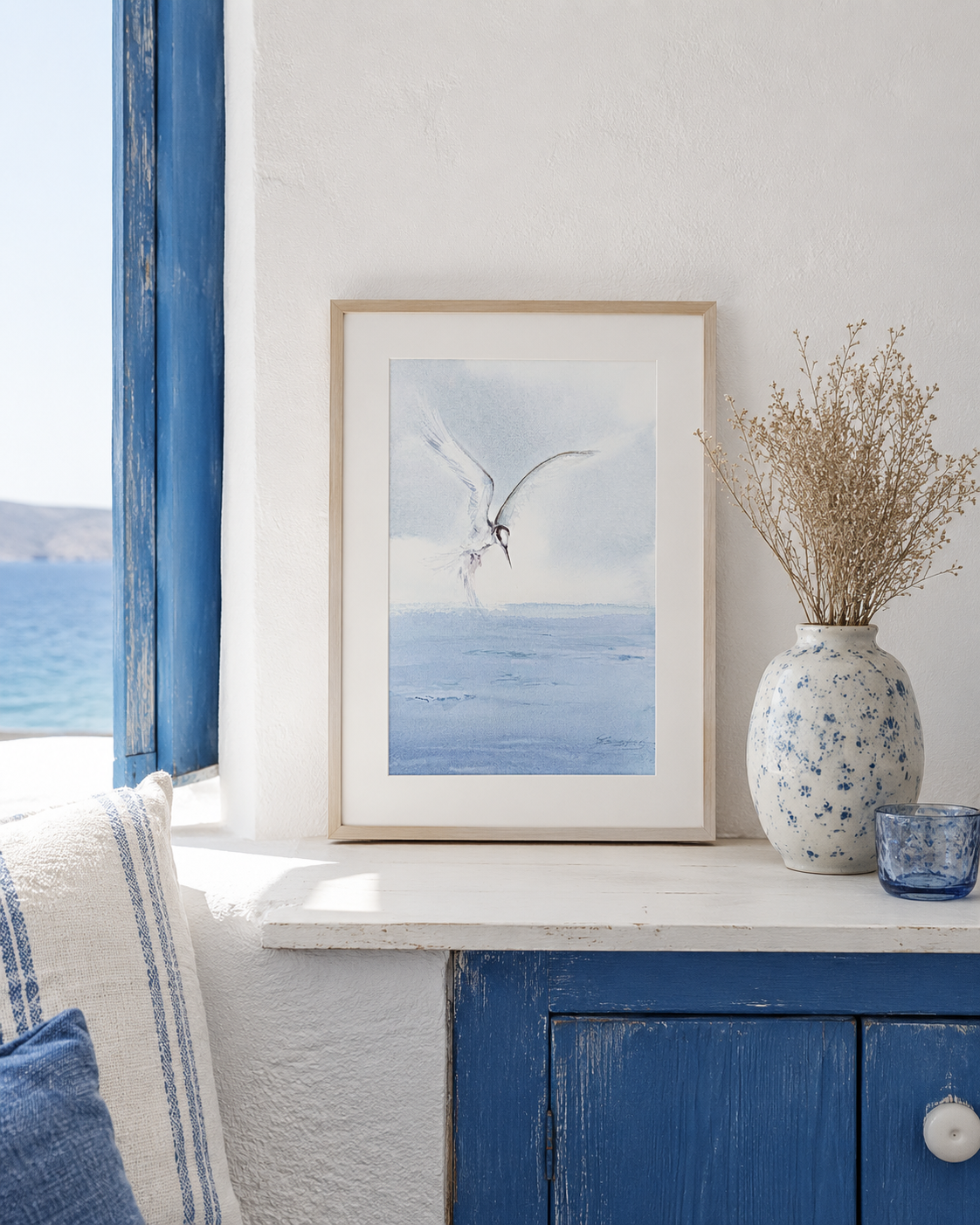 Minimal watercolor painting of a white seabird flying above calm blue ocean in soft pastel tones, coastal artwork by Martina Hastal.